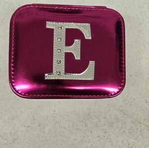 Pink Metallic Zip-Up Jewelry Case With A Silver E On Top
